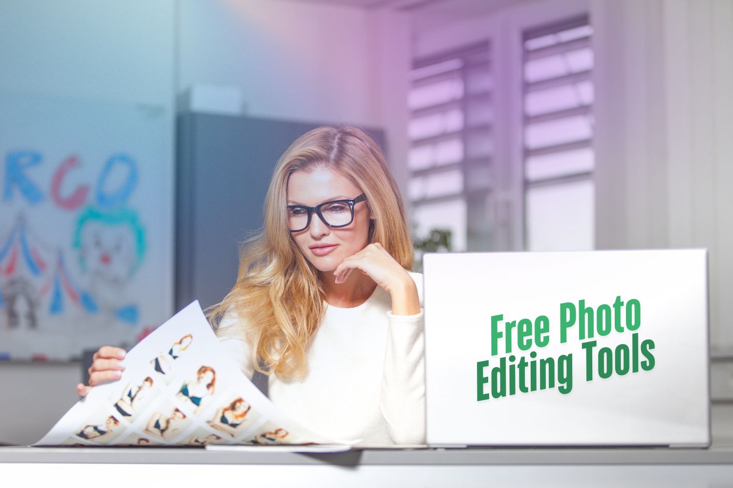 A lady sitting in front of laptop with her printed photos which she edited by free photo editing tool